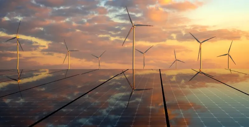 Natural light photovoltaic panels and wind turbines in the light of the rising sun