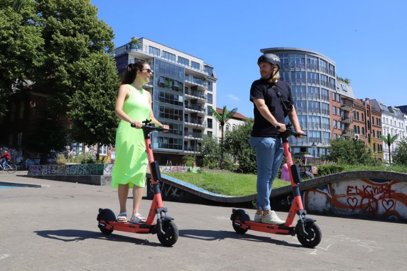 Couple riding electric scooters