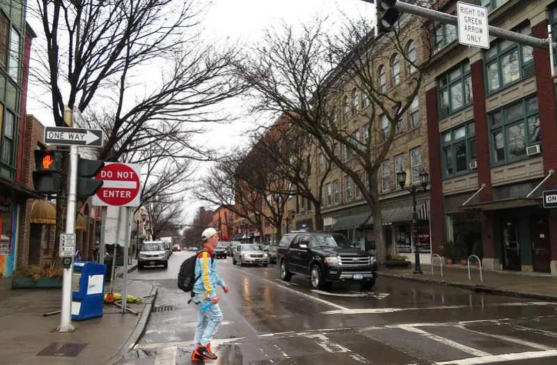 a guy crossing a pedestrian lane