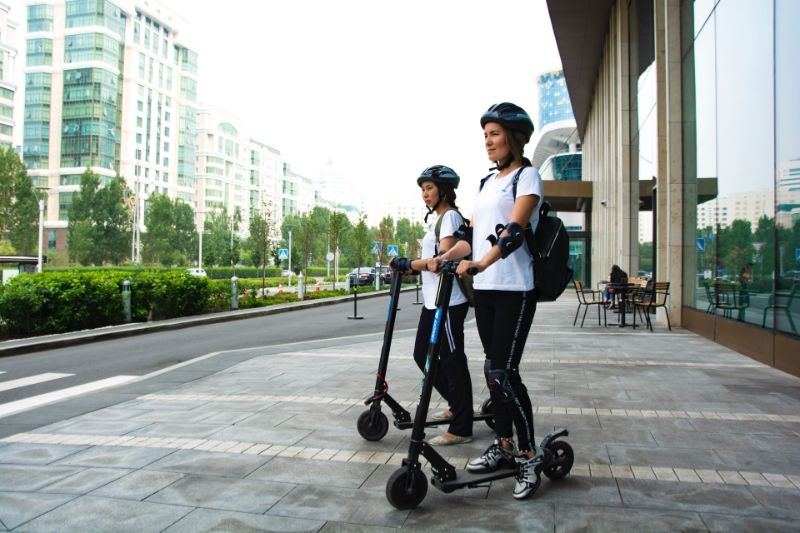 Two women with electric scooters