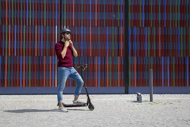 A man on a scooter on the street