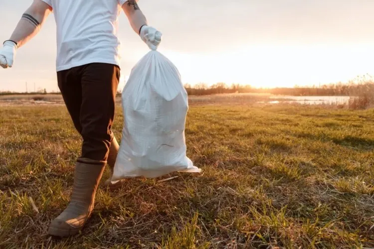 10 Ways to Save Animals Facing Extinction 7 Man Holding a Trash Bag and Wearing Gloves