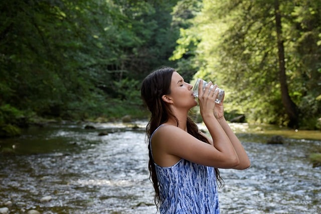 a girl drinking clean unpolluted river water