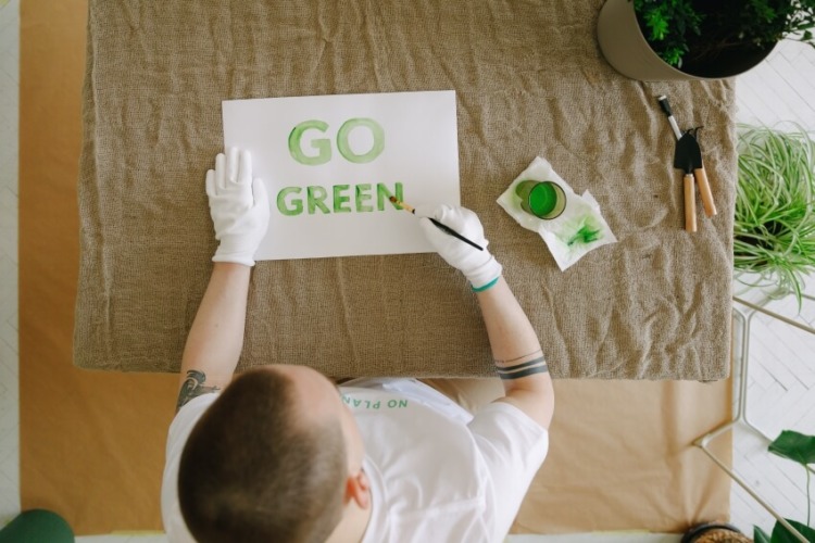 Man Making a Go Green Campaign Card