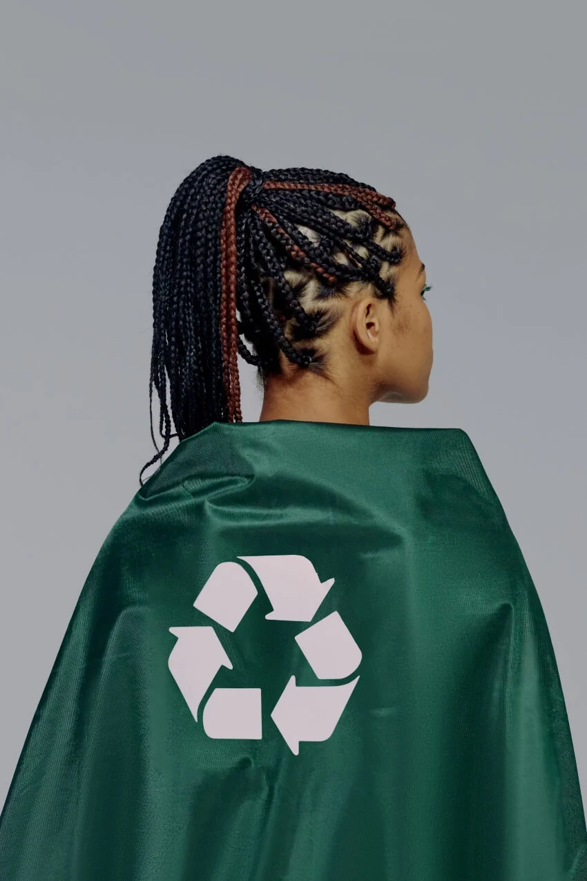 Woman Wearing a Green Cape with Recycle Symbol