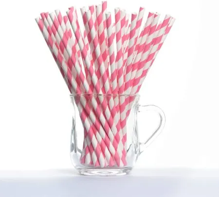 Pink striped biodegradable straws in a glass cup