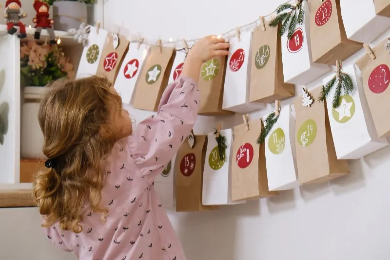 Kid takes  bag with dates from the wall at home