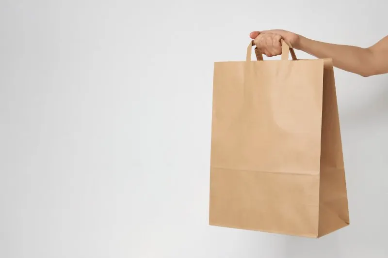 Woman holding brown paper bag
