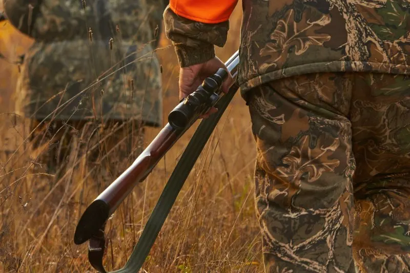 What Is The Hunter’s Role In Wildlife Conservation? 7 Man holding gun in his hand and walking