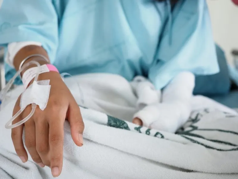 Focus on the hand of a patient in hospital ward