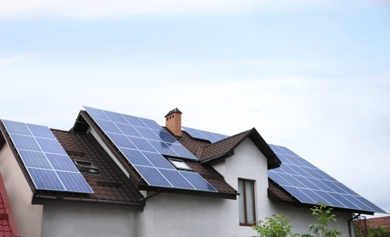 House with installed solar panels on roof.