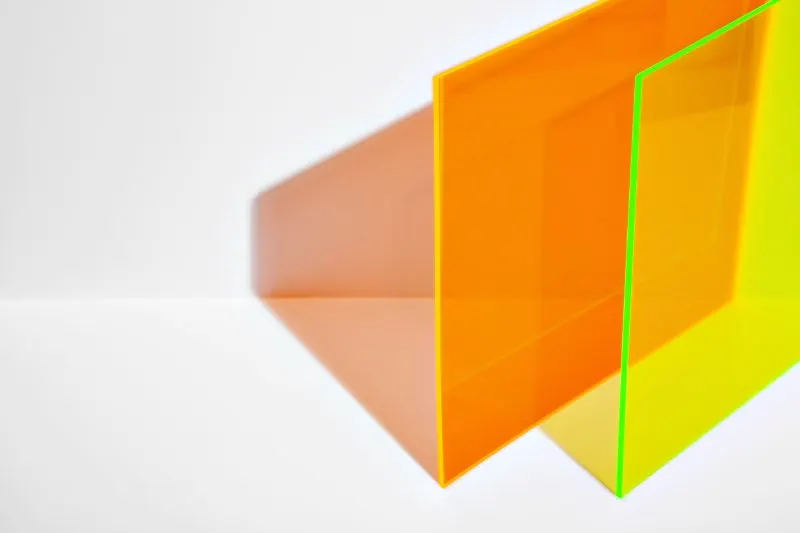Is Acrylic Bad for the Environment? 3 orange and neon yellow acrylic sheet white background.