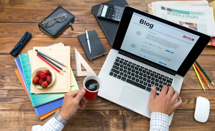 Earth Day Checklist: 21 Things to Do on This Day 21 Over shoulder view man writing managing trip diary on a blog
