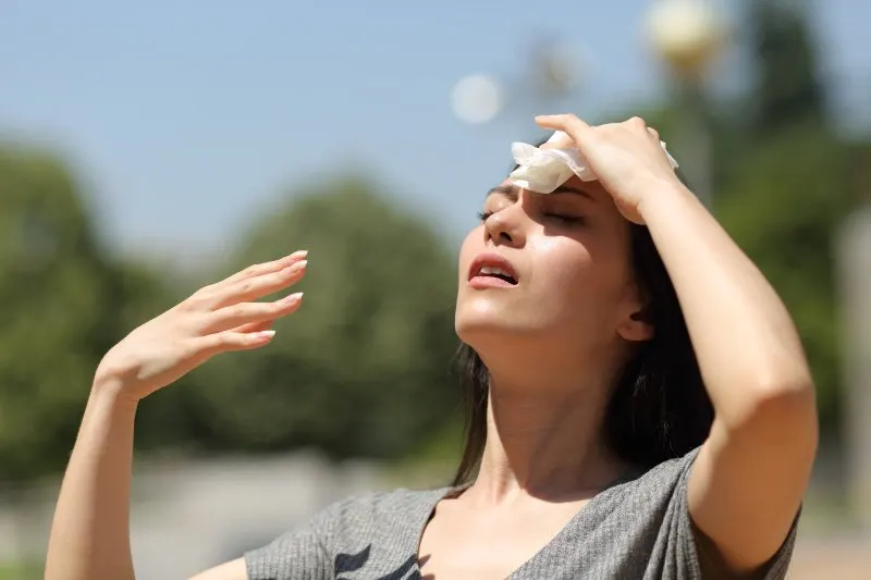 woman drying sweat with a cloth