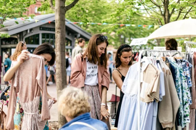14 Easy Ways To Reduce Waste at Home 4 People buying clothes from Thrift store