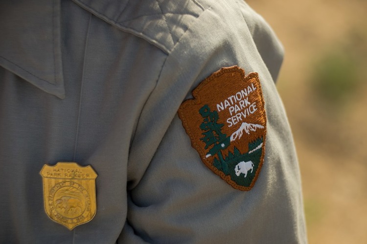 A national park servic badge on a ranger's uniform
