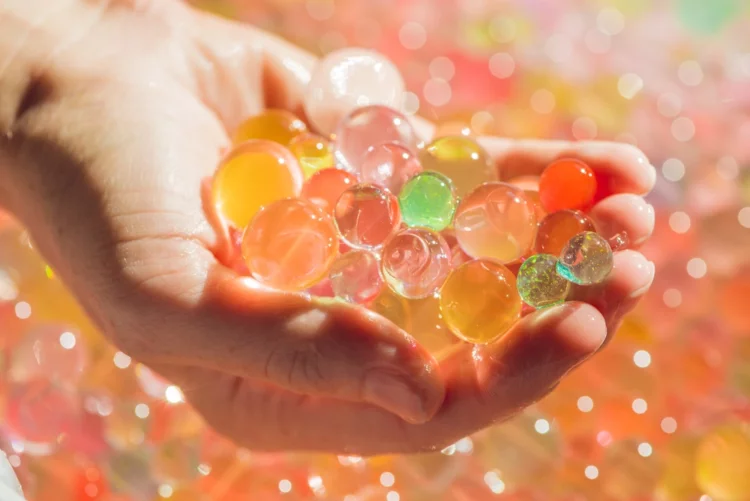 Are Orbeez Biodegradable? 25 Things to Know 4 colorful orbeez on palm