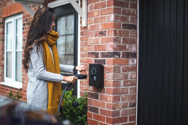 Woman Connecting  a Car on a Charging Port