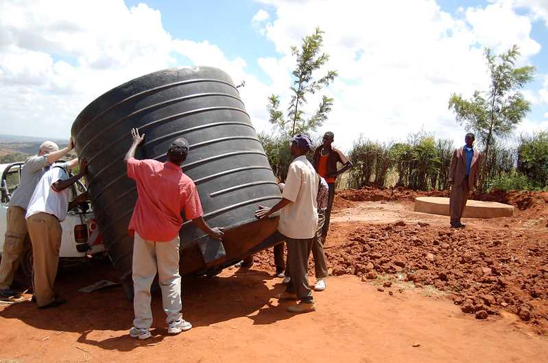 13 Best Off-Grid Water Systems 12 People caring a water storage tank