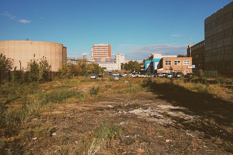 Cars parked in a vacant land