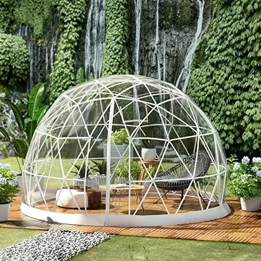 dome greenhouse with coffee table and chair in a garden