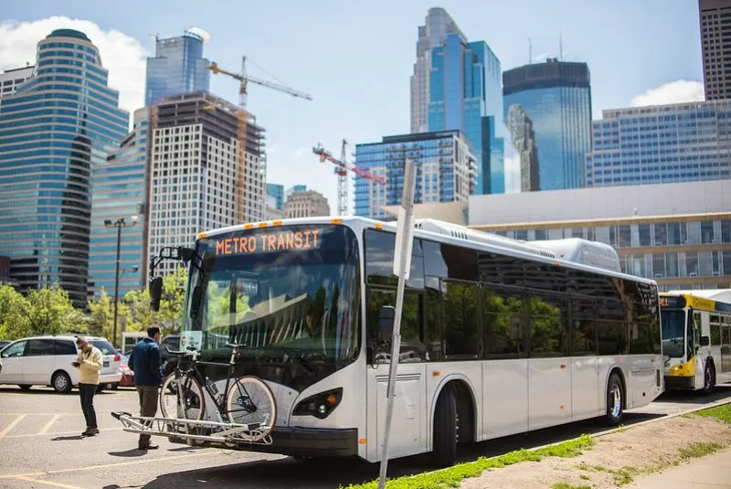 Electric Bus in a city with huge buildings