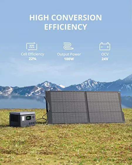 Solar Panel and generator on a green field with mountains at the back