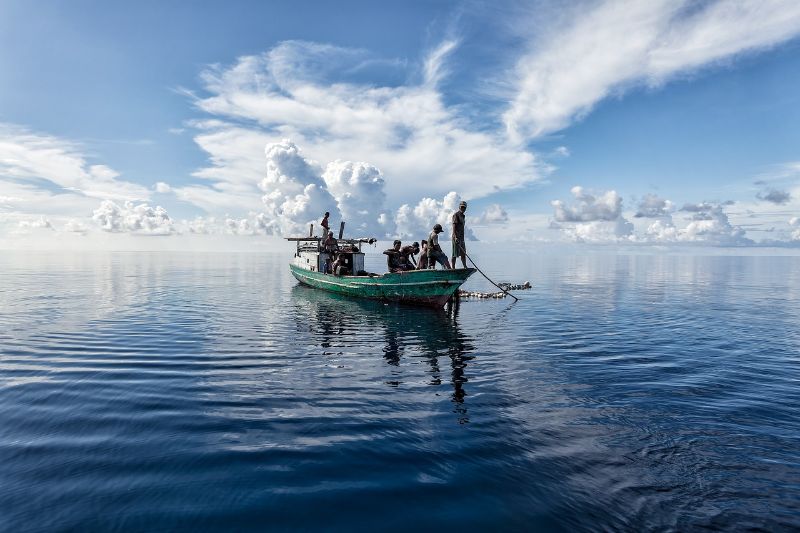 Men on a boat fishing on the sea