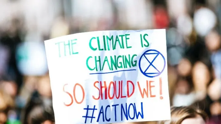 climate change banner in a crowd of people