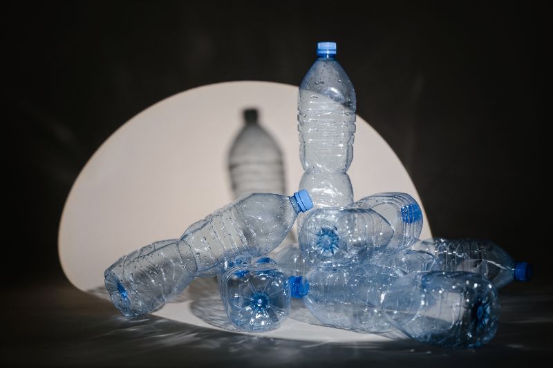 empty plastic bottles under a spotlight