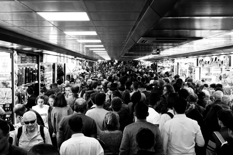 grayscale photo of overcrowded people