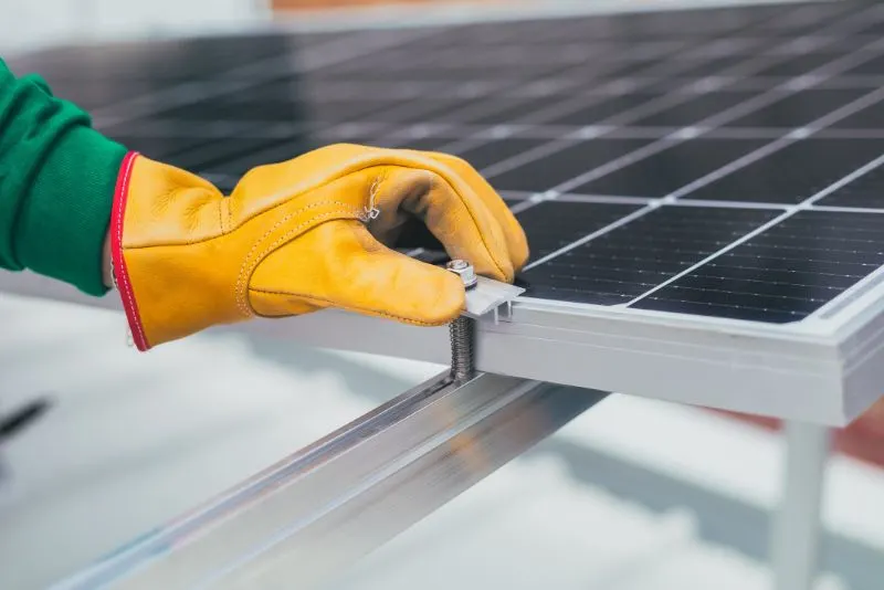 a person's hand on a solar panel