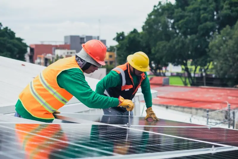 two solar technicians installing solar panels