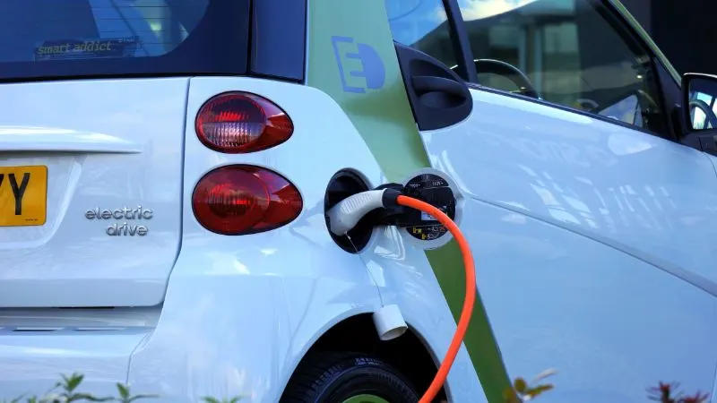 white and orange gasoline nozzle in a car