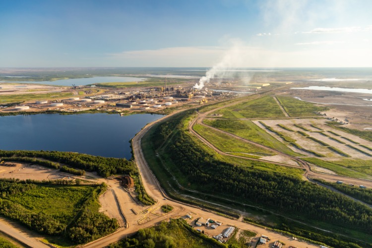 Aerial view of Petroleum Industrial oil mining site in the Athabasca tar sands region near Fort McMurray Athabasca river travel Alberta Canada
