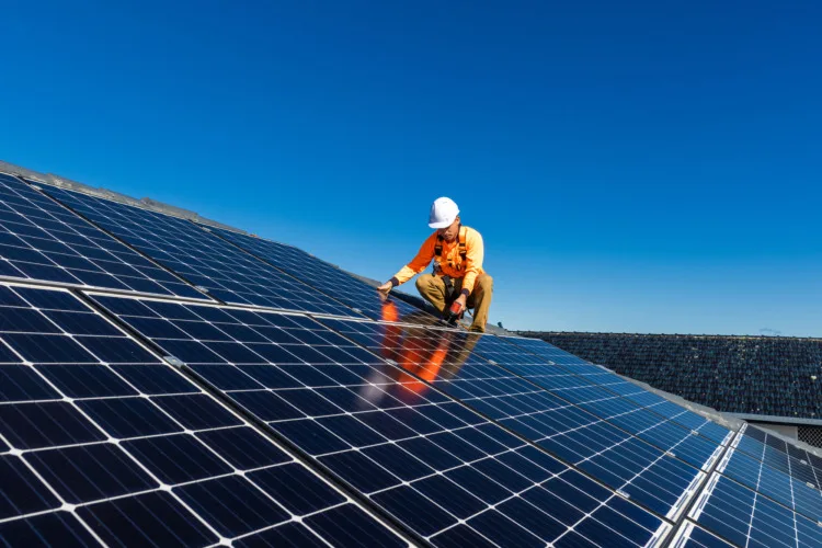 Mastering Solar Panel Direction: A Guide to Optimal Energy Harvesting 3 Solar panel technician with drill installing solar panels