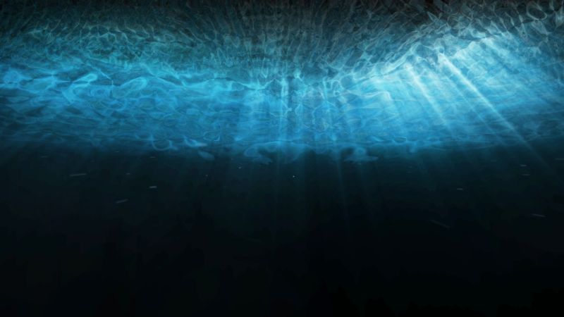 Deep blue sea underwater with sunlight rays shining through
