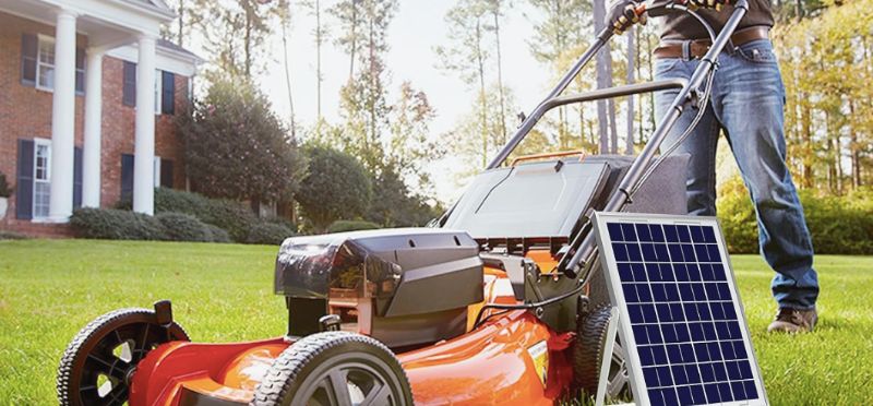 Man with lawn mowing machine and Solperk solar panel