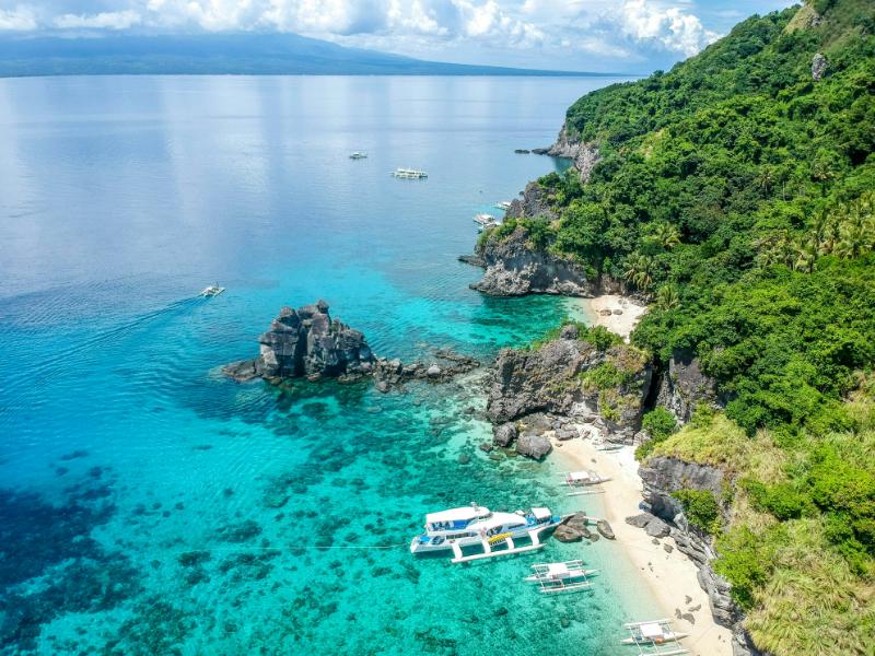 Marine Conservation Diving Tourism Guide 2026 5 Boats and clear coastal water at Apo Island in the Philippines
