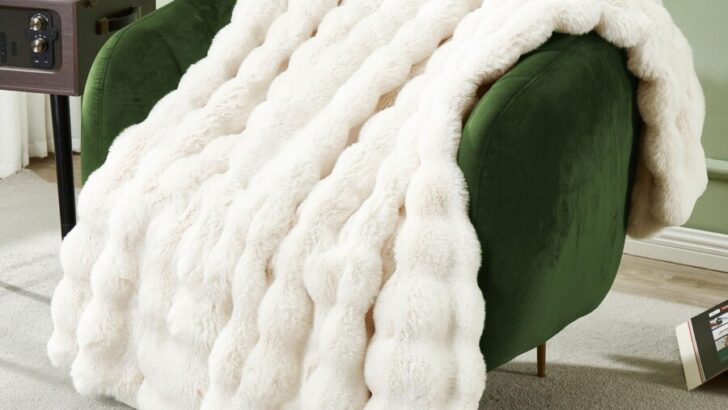 Faux fur blanket on a green accent chair