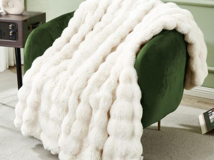 Faux fur blanket on a green accent chair