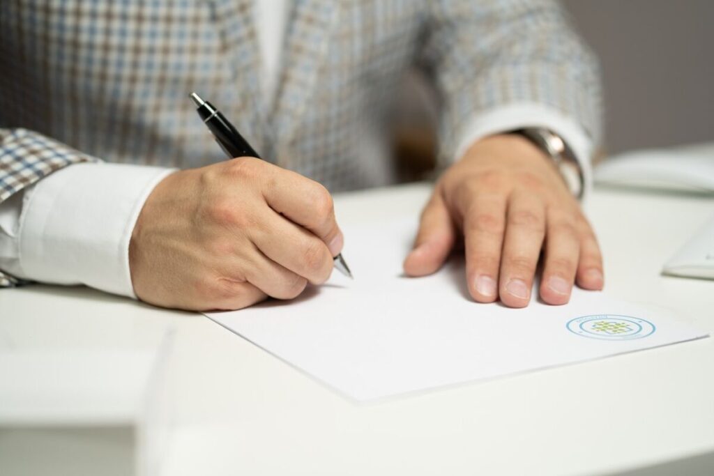 Man signing a certificate