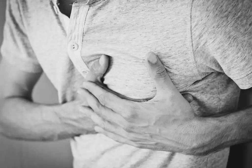 Man holding chest due to a chest pain
