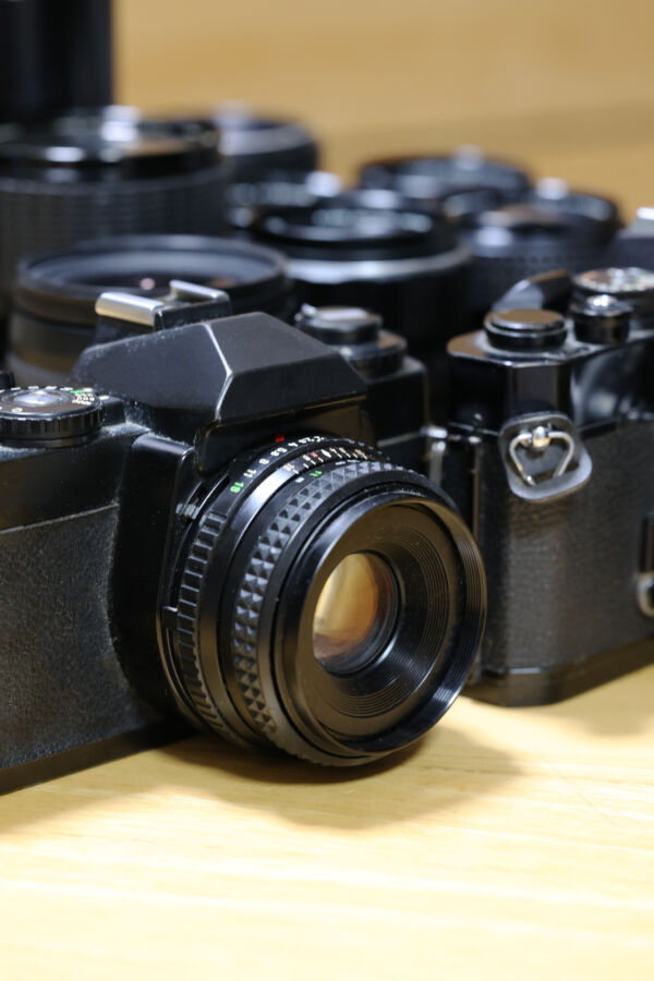 Wildlife Photography Guide: Ethical Camera Settings, Gear, and Fieldcraft 9 Close-up of a camera resting on a table, showcasing its design and features.