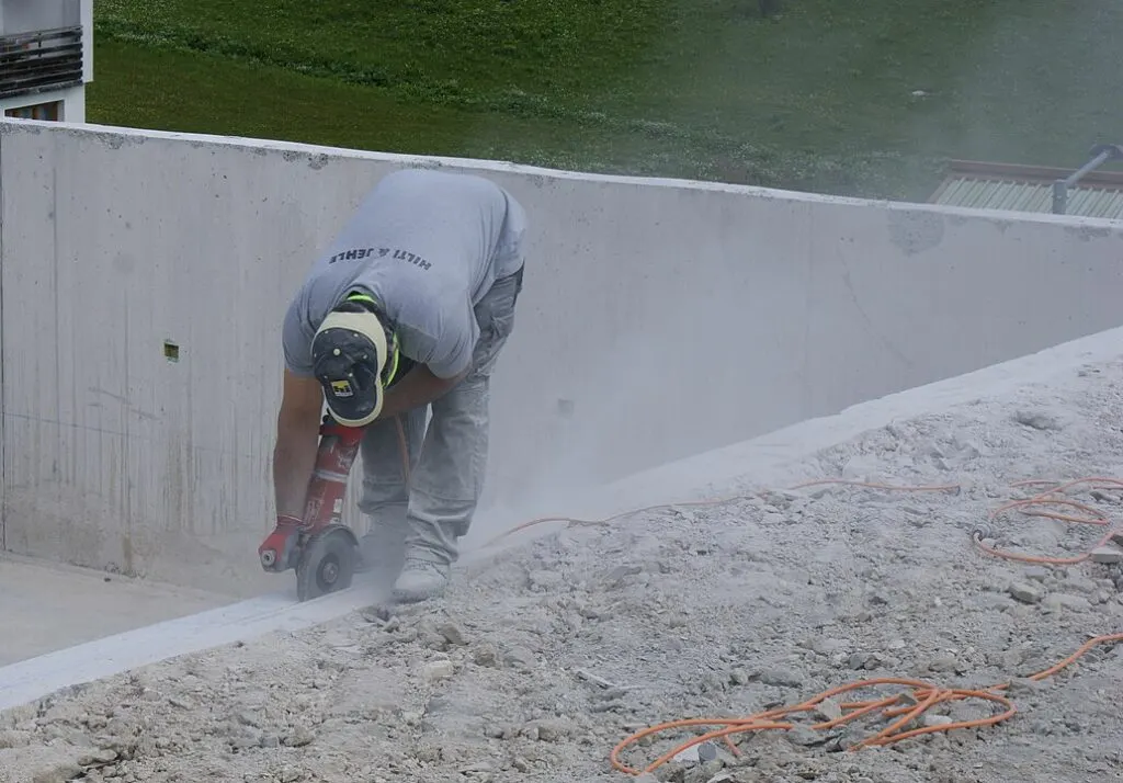 Is Silica Bad for the Environment? 3 Man cutting concrete with an angle grinder