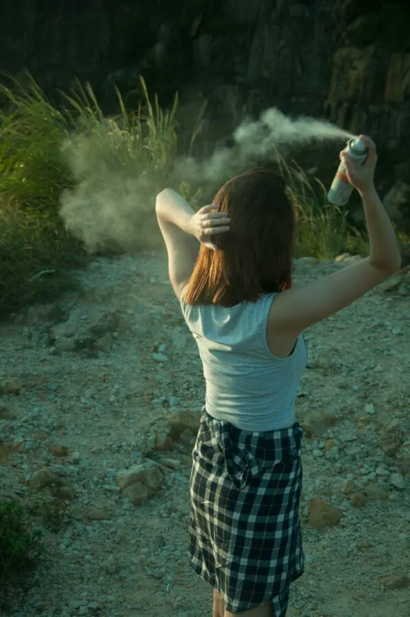 Is Dry Shampoo Bad for the Environment? 5 Woman spraying dry shampoo