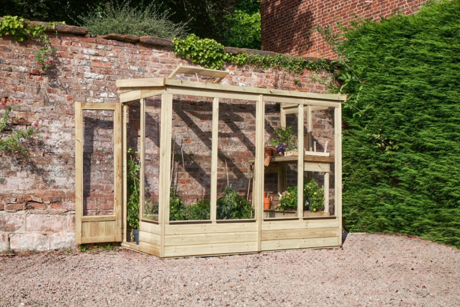 16 Best Lean-To Greenhouses for Small Yards & Side Walls 14 Wooden greenhouse containing an array of plants, illustrating a lush forest garden wallscape.