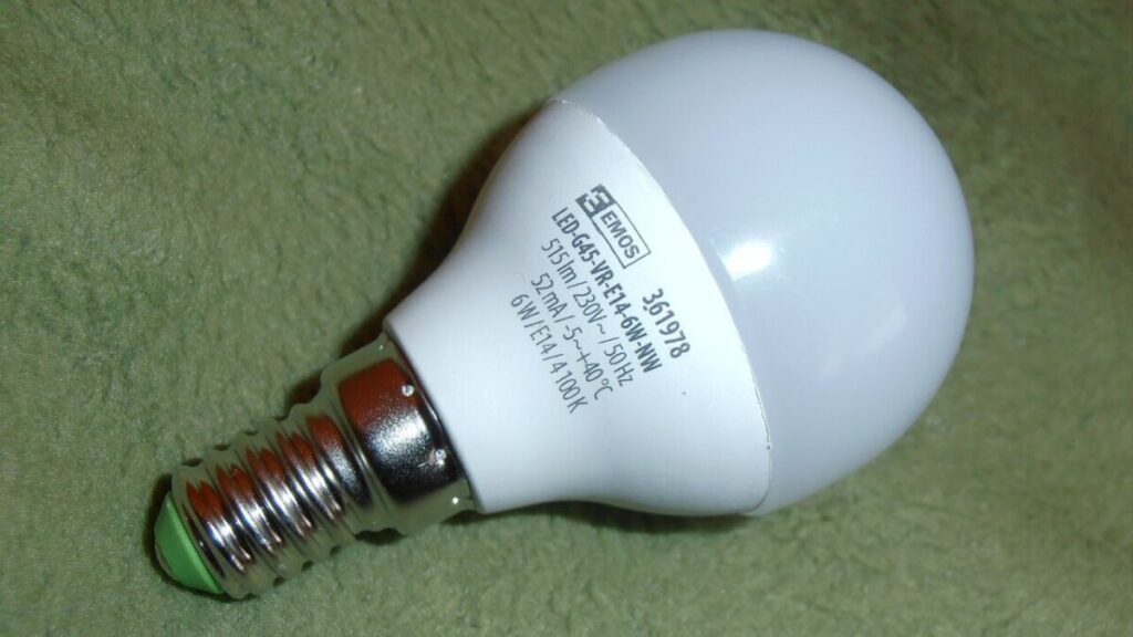 Do Energy-Efficient Light Bulbs Give Off Radiation? 5 White LED light bulb with green inscriptions, highlighting its eco-friendly attributes.