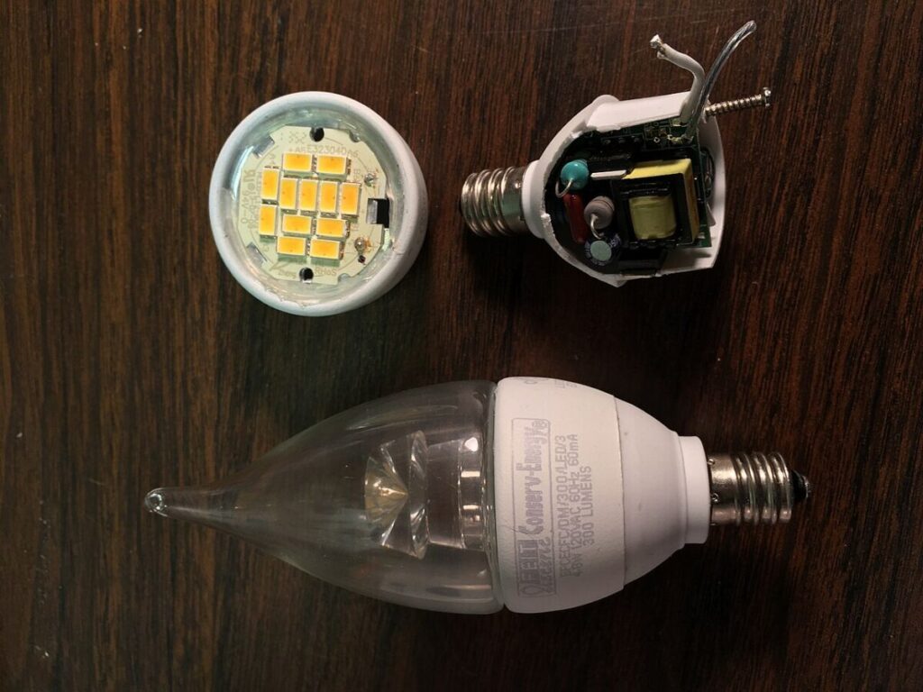 Do Energy-Efficient Light Bulbs Give Off Radiation? 14 Two types of LED light bulbs displayed on a table, showcasing their internal components and design differences.