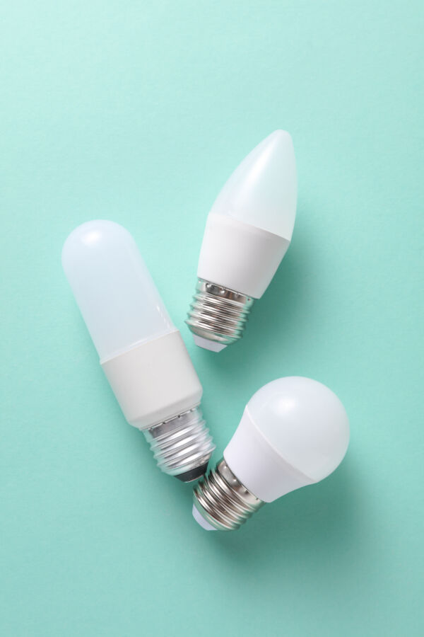 Do Energy-Efficient Light Bulbs Give Off Radiation? 3 Various LED light bulbs in different shapes displayed against a mint green background.